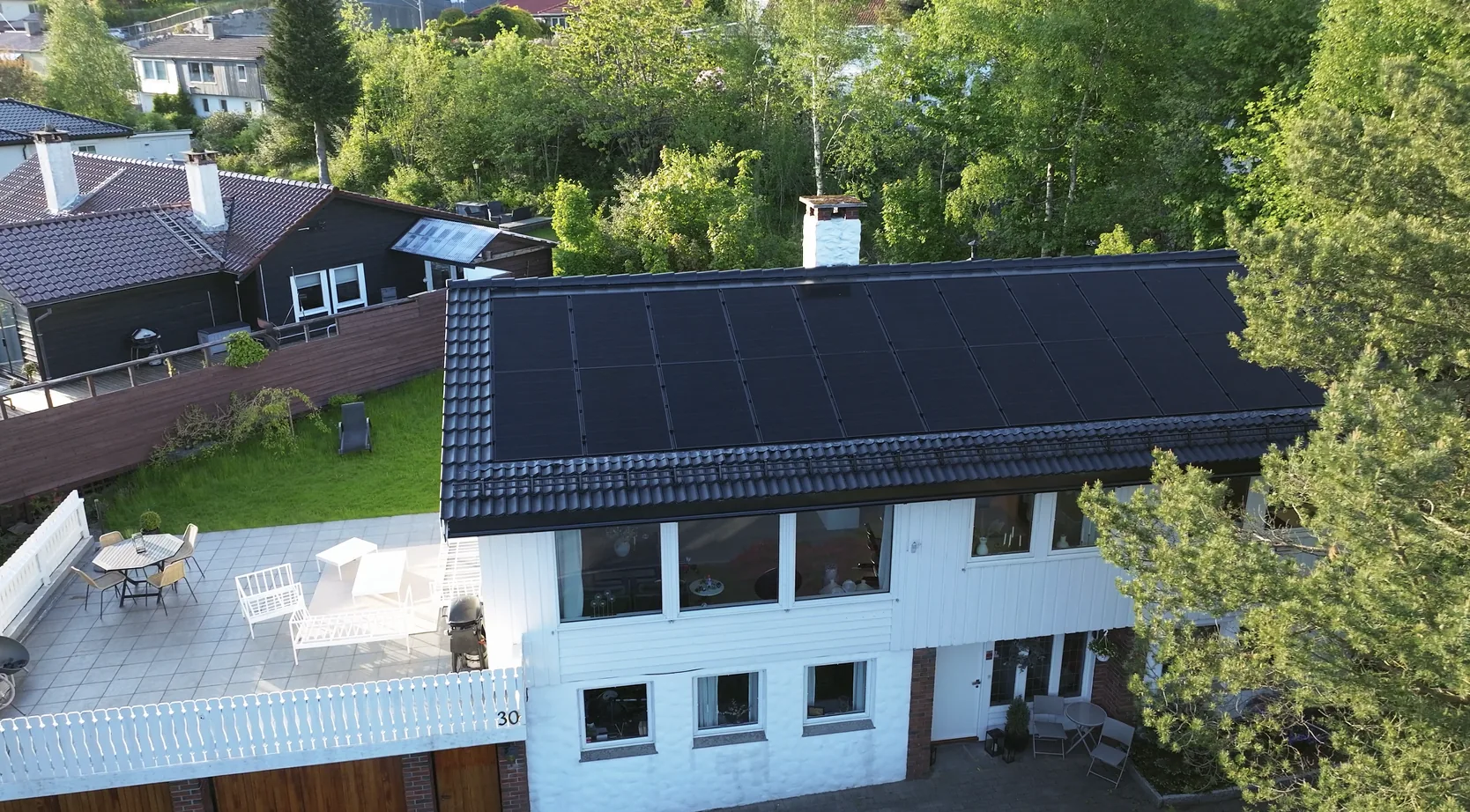Aerial drone view of solar panel installation on Norwegian rooftop — thermal inspection target