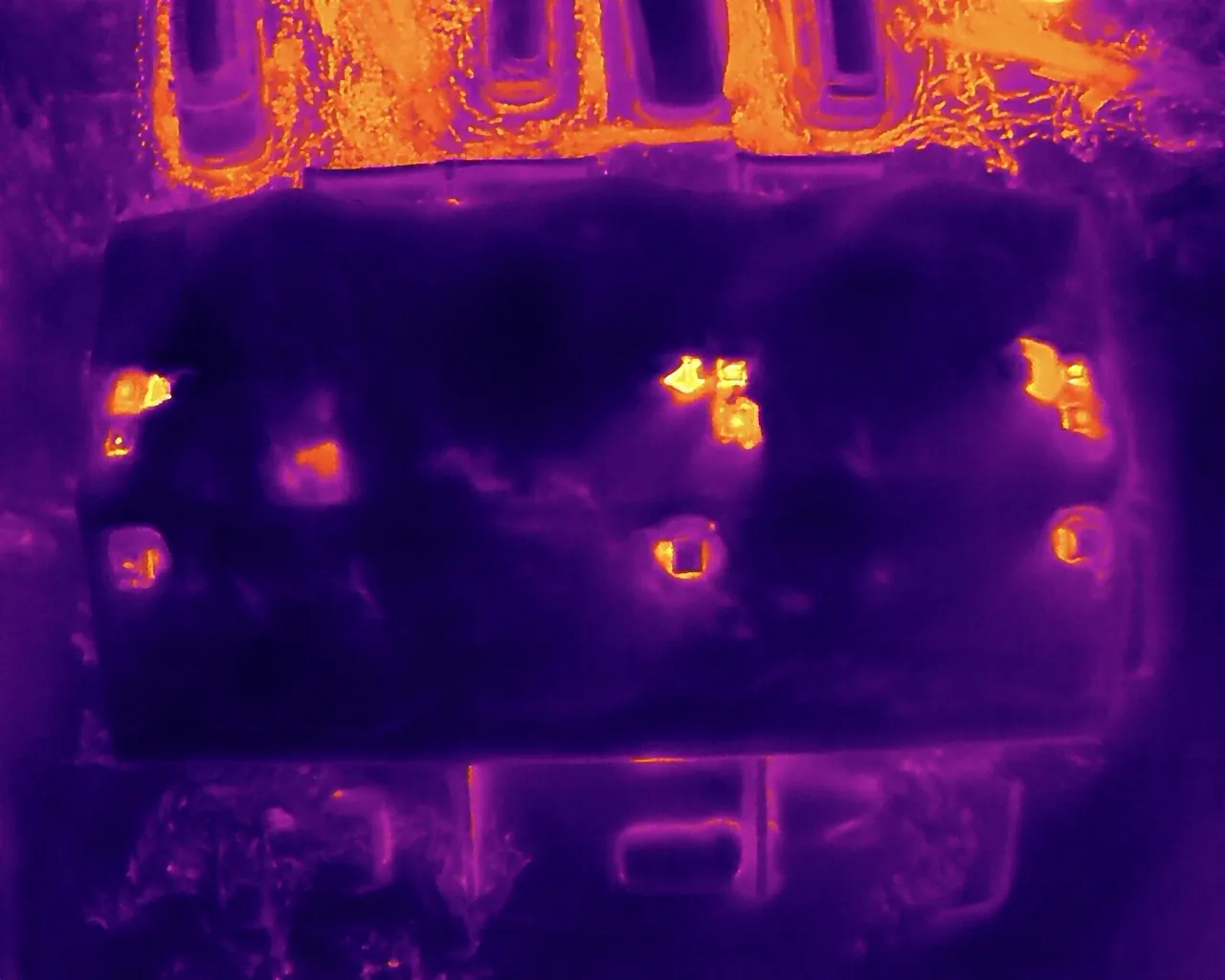 Aerial drone thermography of a building — heat-loss anomalies visible from infrared imagery